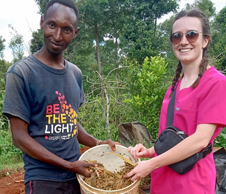 PHOTO: Riley on a farm visit to assist a young farmer in cow nutrition.